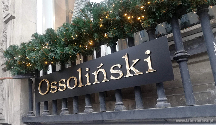 Tablica z czarnego dibondu, litery przestrzenne z plexy lustrzanej, złotej "Ossoliński"